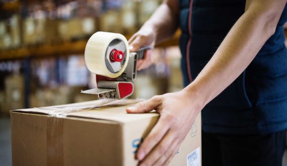 male-warehouse-worker-sealing-cardboard-boxes-PSKUTTE.jpg